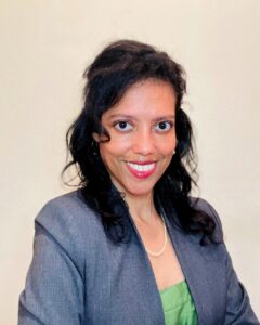 Dr. Gaudys L. Sanclemente, founder of LAXURYS, in gray blazer and green top.